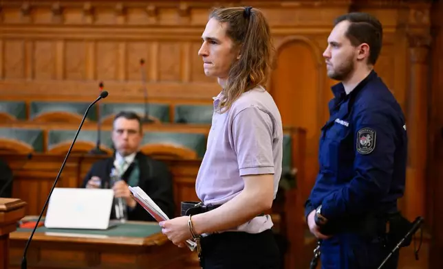 Maja T., a German anti-fascist activist, accused of assaulting and injuring neo-Nazis in Budapest in Feb. 2023, who faces 24 years in prison, grimaces while reading a statement in court in Budapest, Hungary, Wednesday, Feb.4, 2026, at the Budapest-Capital Regional Court. (AP Photo/Denes Erdos)