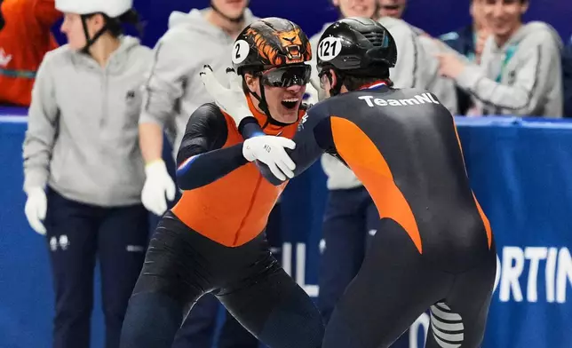 Melle van 't Wout of the Netherlands wins silver, right, and Jens van 't Wout of the Netherlands wins bronze during the short track speed skating men's 500m at the 2026 Winter Olympics, in Milan, Italy, Wednesday, Feb. 18, 2026. (AP Photo/Stephanie Scarbrough)