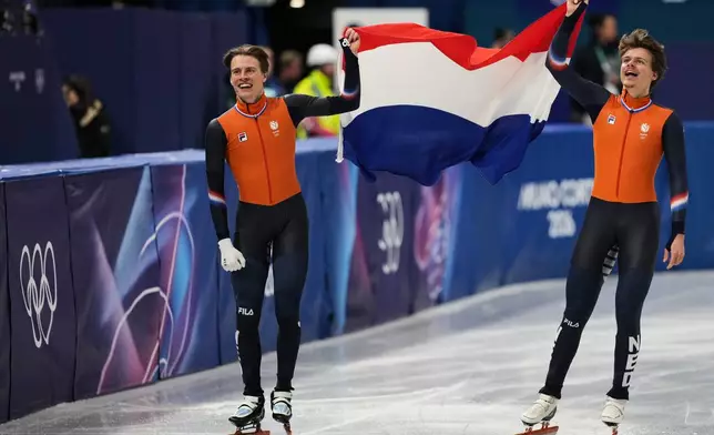 Melle van 't Wout of the Netherlands wins silver, right, and Jens van 't Wout of the Netherlands wins bronze during the short track speed skating men's 500m at the 2026 Winter Olympics, in Milan, Italy, Wednesday, Feb. 18, 2026. (AP Photo/Stephanie Scarbrough)