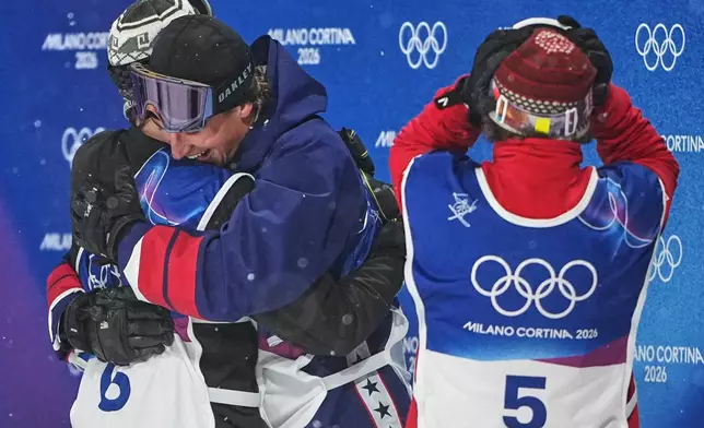 From left, gold medalist Norway's Tormod Frostad, silver medalist United States' Mac Forehand and bronze medalist Austria's Matej Svancer react after the men's freestyle skiing big air finals at the 2026 Winter Olympics, in Livigno, Italy, Tuesday, Feb. 17, 2026. (AP Photo/Lindsey Wasson)