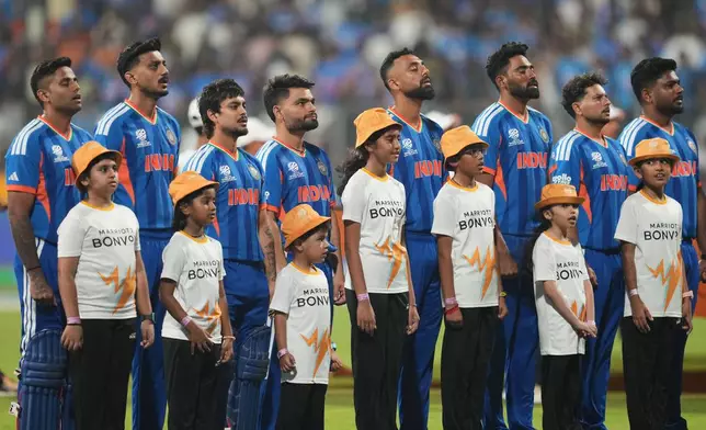 India's players stand up for the national anthems before the start of the T20 World Cup cricket match between India and the United States in Mumbai, India, Saturday, Feb. 7, 2026. (AP Photo/Rafiq Maqbool)