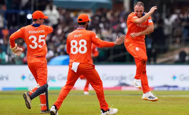 Netherlands' Kyle Klein, right, celebrates with teammates the wicket of Pakistan's Mohammad Nawaz during the T20 World Cup cricket match between Netherlands and Pakistan in Colombo, Sri Lanka, Saturday, Feb. 7, 2026. (AP Photo/Eranga Jayawardena)