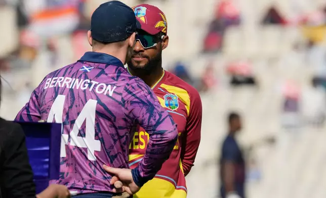 West Indies' captain Shai Hope, right, and Scotland's captain Richie Berrington gesture before start of the T20 World Cup cricket match between Scotland and West Indies in Kolkata, India, Saturday, Feb. 7, 2026. (AP Photo/Bikas Das)