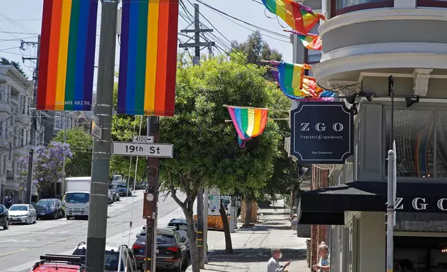 Rainbow banners hang in the Castro District Thursday, June 25, 2020, in San Francisco. As San Francisco Pride turns 50 without its signature parade down Market Street and Civic Center party due to the coronavirus pandemic, LGBTQ individuals and their allies are marking the milestone in other ways. Pride weekend will be kicked off with a pink torch procession from Oakland to San Francisco. Mayors London Breed and Libby Schaaf are scheduled to take part. (AP Photo/Ben Margot)
