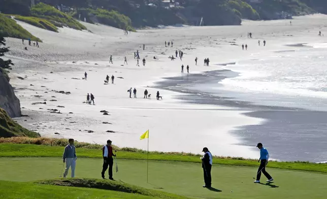 FILE - In this Feb. 6, 2013, file photo, Roberto Castro, right, walks to his ball on the tenth green of the Pebble Beach Golf Links during a practice round of the AT&amp;T Pebble Beach Pro-Am golf tournament in Pebble Beach, Calif. It's played on one of the world's most picturesque courses on the first weekend after the Super Bowl, offering magnificent views of the Monterey Peninsula to golf fans still digging out from the snow. (AP Photo/Eric Risberg, File)