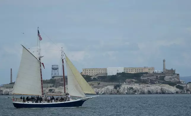 A boat sails in front of Alcatraz Island in San Francisco, Friday, Oct. 10, 2025. (AP Photo/Jeff Chiu)