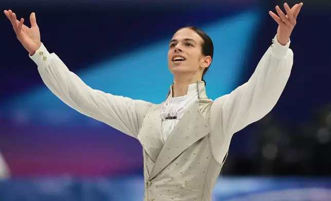 Petr Gumennik of Individual Neutral Athletes competes during the men's free skate program in figure skating at the 2026 Winter Olympics, in Milan, Italy, Friday, Feb. 13, 2026. (AP Photo/Natacha Pisarenko)