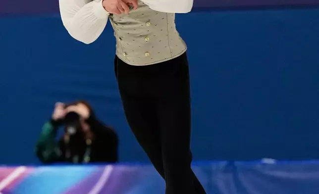 Petr Gumennik of Individual Neutral Athletes competes during the men's free skate program in figure skating at the 2026 Winter Olympics, in Milan, Italy, Friday, Feb. 13, 2026. (AP Photo/Ashley Landis)