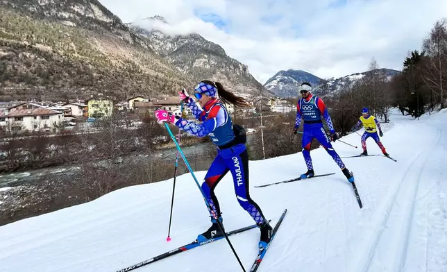 Olympic cross-country skiers from Thailand ski along the Marcialonga trail, during the 2026 Winter Olympics, in Ziano di Fiemme, Italy, Saturday, Feb. 7, 2026. (AP Photo/Brian Melley)