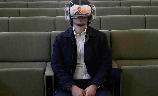 A journalist wears a 3D visor projecting scenes from the life of St. Francis during the first public display of the saint’s bones inside the Basilica of St. Francis, marking the 800th anniversary of his death, in Assisi, Italy, Sunday, Feb. 22, 2026. (AP Photo/Gregorio Borgia)