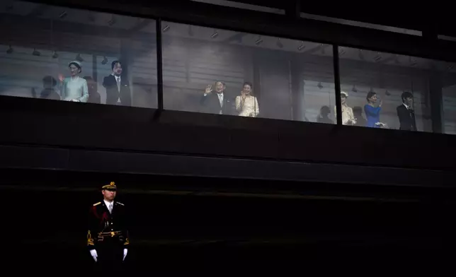 Japan's Emperor Naruhito and Empress Masako, center, along with other members of the imperial family, wave to well-wishers from a balcony during a public appearance marking the emperor's 66th birthday at the Imperial Palace in Tokyo, Monday, Feb. 23, 2026. (AP Photo/Louise Delmotte)