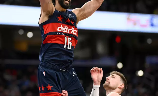 Washington Wizards forward Anthony Gill (16) dunks over Indiana Pacers center Micah Potter, right, during the second half of an NBA basketball game, Friday, Feb. 20, 2026, in Washington. (AP Photo/Nick Wass)