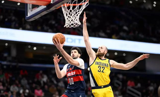 Washington Wizards forward Tristan Vukcevic (00) goes to the basket against Indiana Pacers center Jay Huff (32) during the second half of an NBA basketball game, Friday, Feb. 20, 2026, in Washington. (AP Photo/Nick Wass)