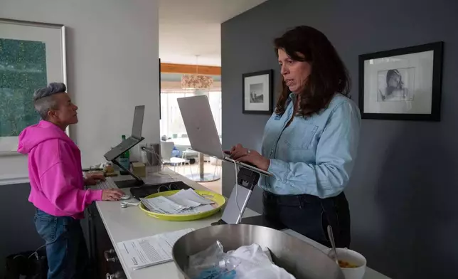 CEO of the Chef Ann Foundation, Mara Fleishman, a winner of this year's Elevate Prize, works alongside her executive assistant Kim Rosenbarger at her home, Monday, Feb. 16, 2026, in Boulder, Colo. (AP Photo/Rebecca Slezak)