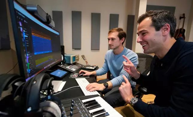 Mikey Shulman, one of the founders of AI music generator startup Suno, right, and research scientist Christian Steinmetz, collaborate on creating a song, Tuesday, Jan. 13, 2026, in Cambridge, Mass. (AP Photo/Robert F. Bukaty)