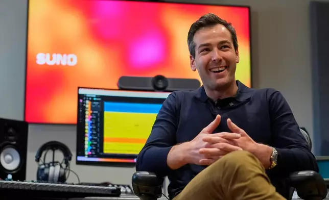 Mikey Shulman, one of the founders of AI music generator startup Suno, speaks to a reporter at company headquarters, Tuesday, Jan. 13, 2026, in Cambridge, Mass. (AP Photo/Robert F. Bukaty)