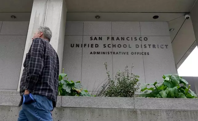 FILE - A pedestrian walks past a San Francisco Unified School District office building in San Francisco, Feb. 3, 2022. (AP Photo/Jeff Chiu, file)