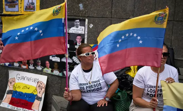 People who consider their detained family members to be political prisoners protest for their releases outside the United Nations office in Caracas, Venezuela, Wednesday Feb. 18, 2026. (AP Photo/Ariana Cubillos)