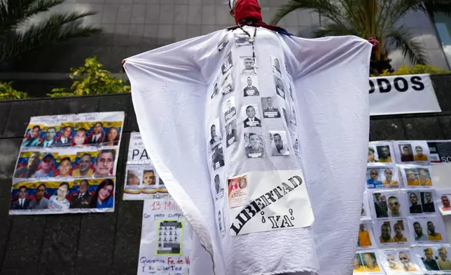 An activist protests outside the United Nations office for the release of what demonstrators consider to be political prisoners in Caracas, Venezuela, Wednesday, Feb. 18, 2026. (AP Photo/Ariana Cubillos)