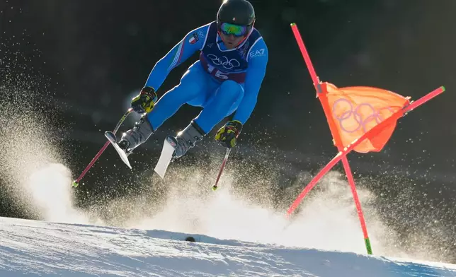 Italy's Mattia Casse speeds down the course during an alpine ski men's downhill portion of a team combined race, at the 2026 Winter Olympics, in Bormio, Italy, Monday, Feb. 9, 2026. (AP Photo/Julia Demaree Nikhinson)
