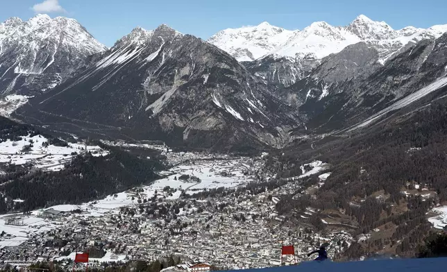 France's Maxence Muzaton speeds down the course of an alpine ski men's downhill portion of a team combined race, at the 2026 Winter Olympics, in Bormio, Italy, Monday, Feb. 9, 2026. (AP Photo/Gabriele Facciotti)