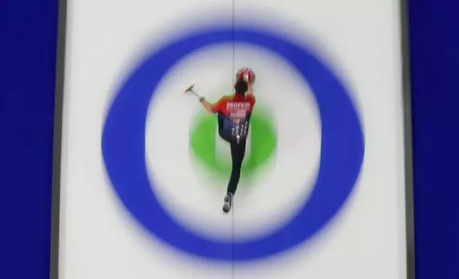 United States' Korey Dropkin delivers a stone against Italy during a curling mixed doubles session at the 2026 Winter Olympics, in Cortina d'Ampezzo, Italy, Monday, Feb. 9, 2026. (AP Photo/David J. Phillip)