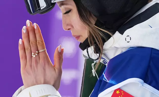 China's Eileen Gu celebrates after her score during the women's freestyle skiing slopestyle finals at the 2026 Winter Olympics, in Livigno, Italy, Monday, Feb. 9, 2026. (AP Photo/Gregory Bull)