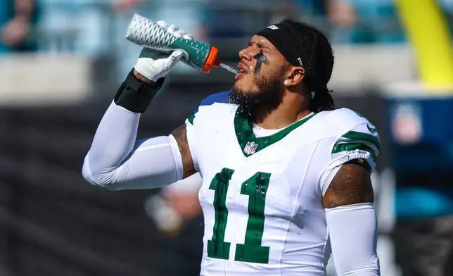 FILE - New York Jets linebacker Jermaine Johnson warms up before an NFL football game against the Jacksonville Jaguars, Dec. 14, 2025, in Jacksonville, Fla. (AP Photo/Gary McCullough)