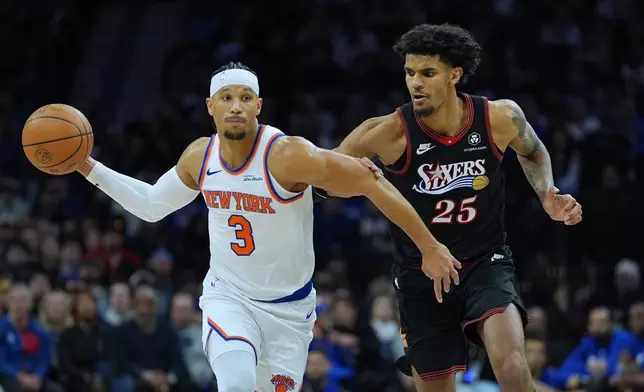 New York Knicks' Josh Hart (3) looks to past past Philadelphia 76ers' Dominick Barlow during the first half of an NBA basketball game, Wednesday, Feb. 11, 2026, in Philadelphia. (AP Photo/Matt Rourke)