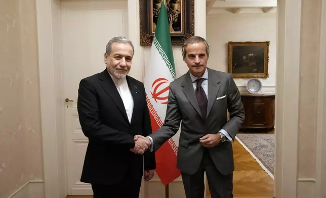 In this photo released by the Iranian Foreign Ministry, Iranian Foreign Minister Abbas Araghchi, left, shakes hands with International Atomic Energy Agency (IAEA) Director-General Rafael Grossi during their meeting in Geneva, Switzerland, Monday, Feb. 16, 2026. (Iranian Foreign Ministry via AP)
