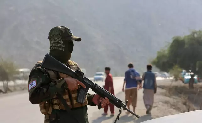 An Afghan Taliban soldier stands in guard on the Afghan side of the Torkham border crossing with Pakistan in Torkham, Afghanistan, Friday, Feb. 27, 2026. (AP Photo/Wahidullah Kakar)
