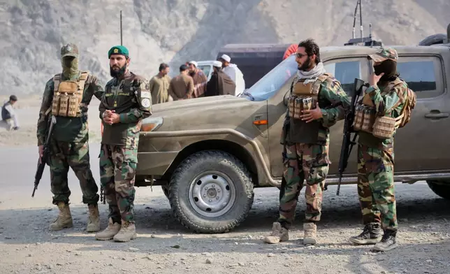 Afghan Taliban soldiers gather on the Afghan side of the Torkham border crossing with Pakistan in Torkham, Afghanistan, Friday, Feb. 27, 2026. (AP Photo/Wahidullah Kakar)