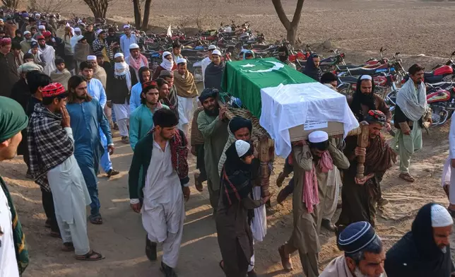 Villagers carry the coffin of a paramilitary soldier killed during a gun-battle with militants in Waziristan area, for his funeral prayers on the outskirts of Kohat, Pakistan, Friday, Feb. 27, 2026. (AP Photo/S.B. Shah)