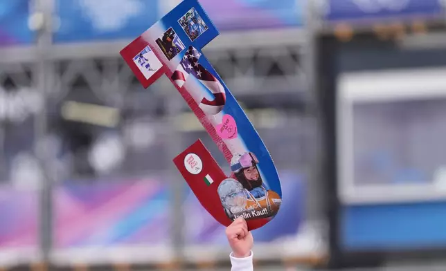 Friends and family hold a sign for United States' Jaelin Kauf before the women's freestyle skiing moguls qualifications at the 2026 Winter Olympics, in Livigno, Italy, Tuesday, Feb. 10, 2026. (AP Photo/Lindsey Wasson)