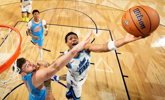 Team Austin guard Alijah Martin (55) of the Toronto Raptors, right, shoots as Team Melo frontcourt Donovan Clingan (23) of the Portland Trail Blazers defends during an NBA basketball's Rising Stars event Friday, Feb. 13, 2026, in Inglewood, Calif. (AP Photo/Mark J. Terrill)