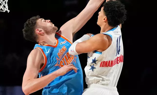 Team Austin frontcourt Yanic Konan Niederhauser (14) of the LA Clippers shoots as Team Melo frontcourt Donovan Clingan (23) of the Portland Trail Blazers defends during an NBA basketball's Rising Stars event Friday, Feb. 13, 2026, in Inglewood, Calif. (AP Photo/Mark J. Terrill)