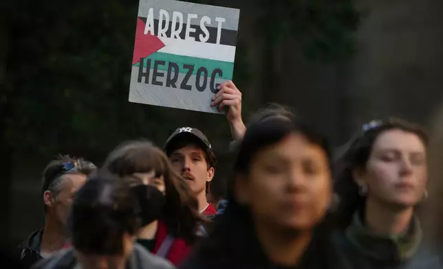 Demonstrators gather in Melbourne, Thursday, Feb. 12, 2026, to protest the visit to Australia by Israeli President Isaac Herzog. (AP Photo/Asanka Brendon Ratnayake)