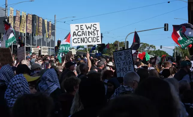 EDS NOTE: OBSCENITY - Demonstrators gather in Melbourne, Thursday, Feb. 12, 2026, to protest the visit to Australia by Israeli President Isaac Herzog. (AP Photo/Asanka Brendon Ratnayake)