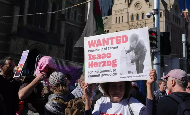 Demonstrators gather in Melbourne, Thursday, Feb. 12, 2026, to protest the visit to Australia by Israeli President Isaac Herzog. (AP Photo/Asanka Brendon Ratnayake)