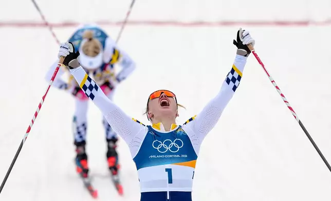 Linn Svahn, of Sweden, crosses the finish line ahead of Jonna Sundling, also of Sweden, to win the gold medal in cross-country skiing women's sprint classic at the 2026 Winter Olympics, in Tesero, Italy, Tuesday, Feb. 10, 2026. (AP Photo/Matthias Schrader)
