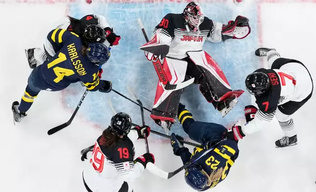 Japan's Rei Halloran makes a save during a preliminary round match of women's ice hockey between Japan and Sweden at the 2026 Winter Olympics, in Milan, Italy, Tuesday, Feb. 10, 2026. (AP Photo/Petr David Josek)