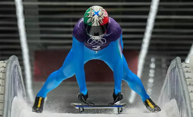 Italy's Amedeo Bagnis arrives at the finish during a men's skeleton training session at the 2026 Winter Olympics, in Cortina d'Ampezzo, Italy, Tuesday, Feb. 10, 2026. (AP Photo/Alessandra Tarantino)