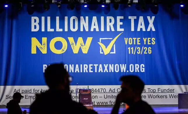A large banner is seen at a campaign event for a proposed "billionaires tax" in Los Angeles, Wednesday, Feb. 18, 2026. (AP Photo/Jae C. Hong)