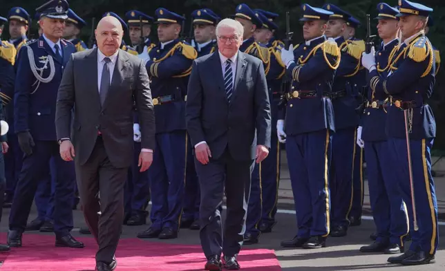 Lebanese President Joseph Aoun, left, review the honor guard with his German counterpart Frank-Walter Steinmeier, at the presidential palace in Baabda, east of Beirut, Lebanon, Monday, Feb. 16, 2026. (AP Photo/Hussein Malla)