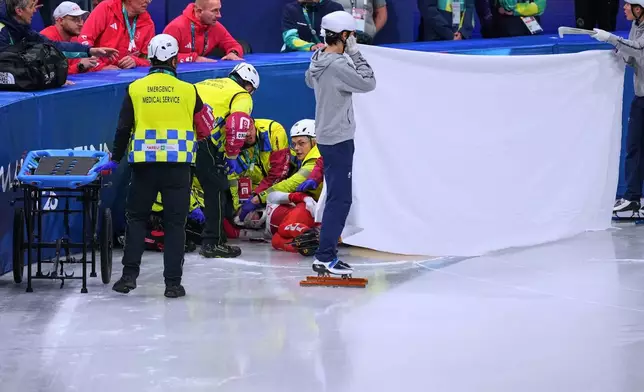 Kamila Sellier of Poland is helped after falling during a short track speed skating women's 1500 meters quarterfinal at the 2026 Winter Olympics, in Milan, Italy, Friday, Feb. 20, 2026. (AP Photo/Stephanie Scarbrough)