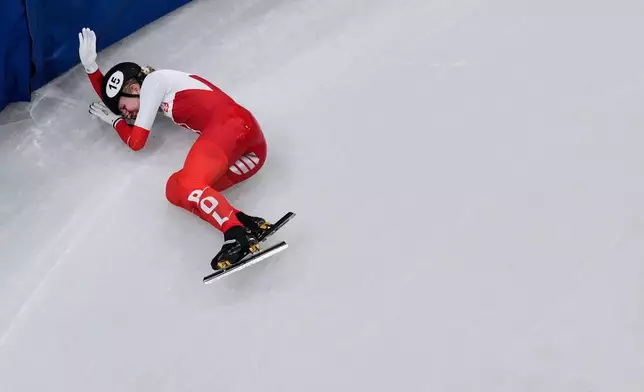 Kamila Sellier of Poland is injured due to a fall during a short track speed skating women's 1500 meters quarterfinal at the 2026 Winter Olympics, in Milan, Italy, Friday, Feb. 20, 2026. (AP Photo/Bernat Armangue)