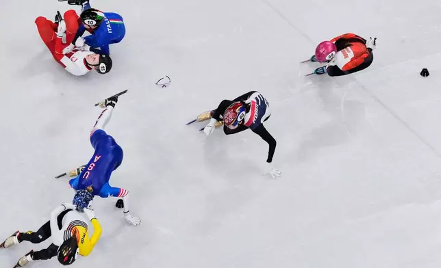 Kamila Sellier of Poland, 15, Arianna Fontana of Italy, 10, and Kristen Santos-Griswold of the United States fall during a short track speed skating women's 1500 meters quarterfinal at the 2026 Winter Olympics, in Milan, Italy, Friday, Feb. 20, 2026. (AP Photo/Bernat Armangue)