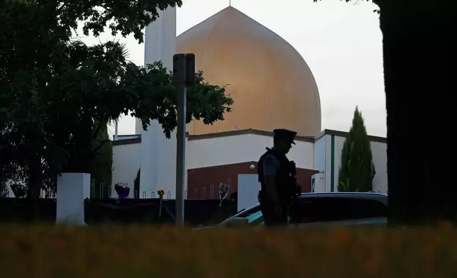 FILE - A police officer stands guard in front of the Al Noor mosque, in Christchurch, New Zealand, March 17, 2019. (AP Photo/Vincent Yu, File)