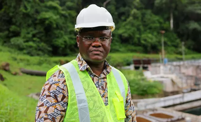 Maada Kpenge, managing director of Guma Valley water company, poses near the water treatment area in Western Area Peninsula National Park, Sierra Leone, Wednesday, July 2, 2025. (AP Photo/Misper Apawu)