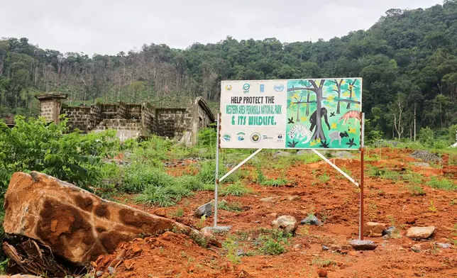 A sign urging protection of the Western Area Peninsula National Park, Sierra Leone, Saturday, July 5, 2025. (AP Photo/Misper Apawu)
